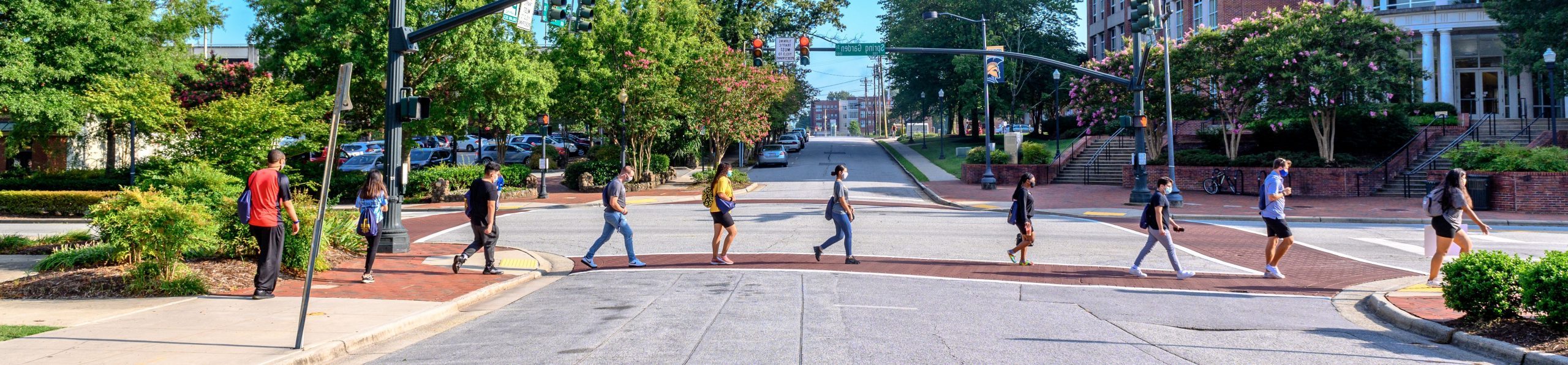 students in a line crossing the intersection of Spring Garden Street and Forest Street